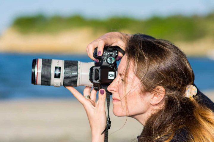 Woman Taking Picture with Canon Lens on Her Traveling Trip
